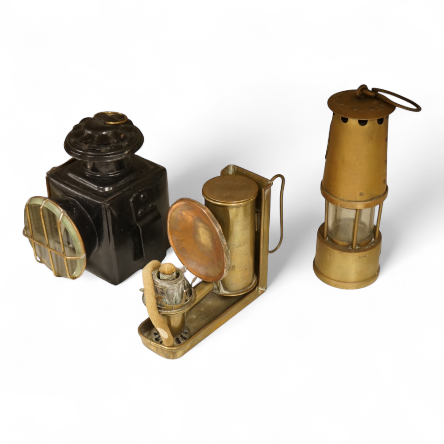 A railway lamp, a vintage Eccles Protector miners lamp and another, largest 17cm high